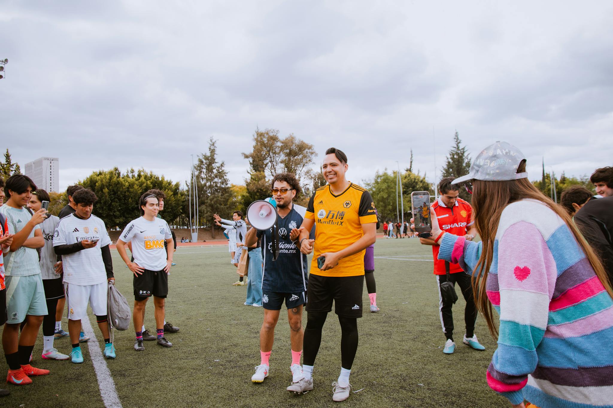 Youth participating in a lively football training session outdoors in Puebla, Mexico.